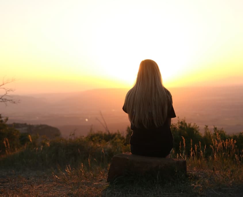 lonely girl overlooking sunset