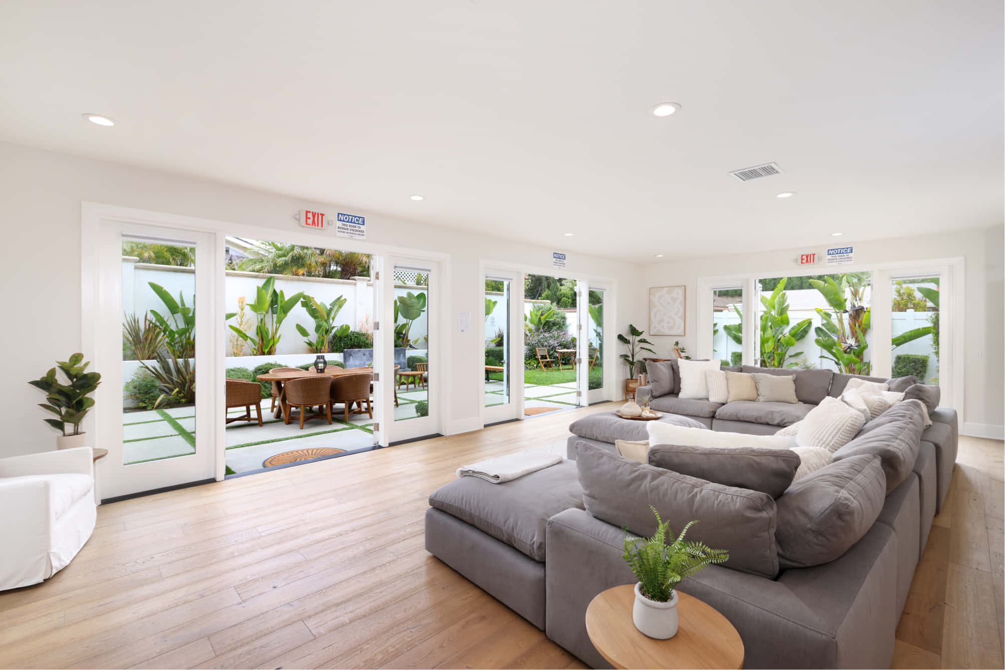 wood floor living room with couches at Alter Irvine location