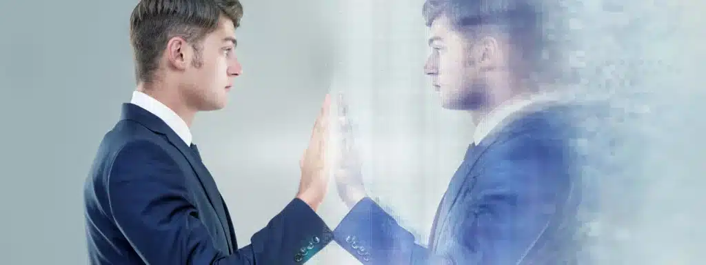 Man in suit touches digital mirror reflection, symbolizing identity loss and mental confusion linked to late-onset schizophrenia and the importance of early mental health intervention.