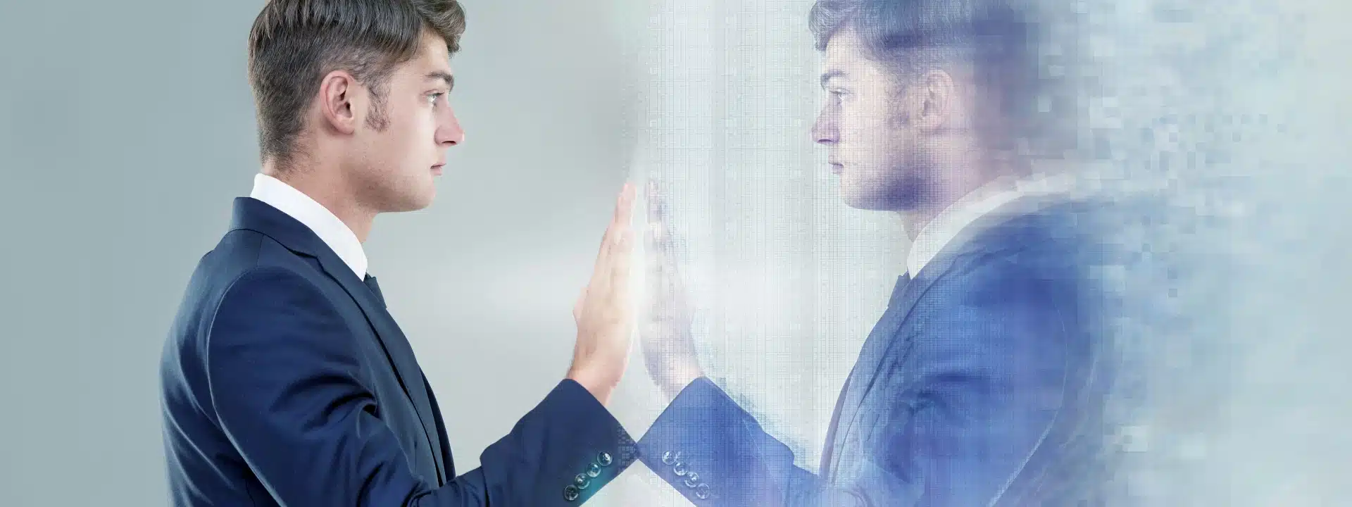 Man in suit touches digital mirror reflection, symbolizing identity loss and mental confusion linked to late-onset schizophrenia and the importance of early mental health intervention.