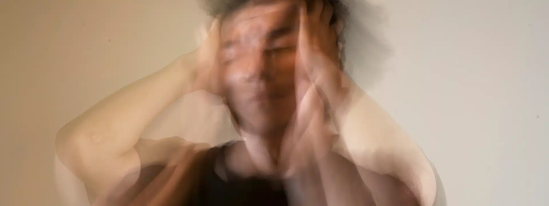 Person experiencing physical and emotional distress during alcohol withdrawal, illustrating the dangers of detoxing without medical supervision.