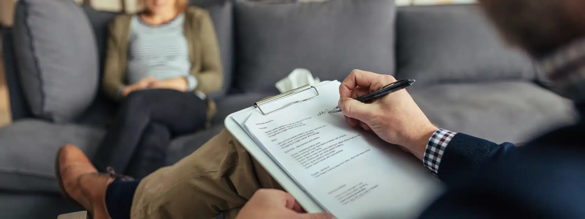 therapist taking notes during a solution-focused therapy session at Alter Behavioral Health helping client set small goals for emotional growth and healing