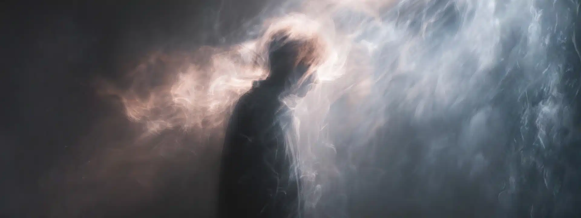 Silhouette surrounded by mist and light representing confusion and withdrawal symptoms after stopping alprazolam suddenly.