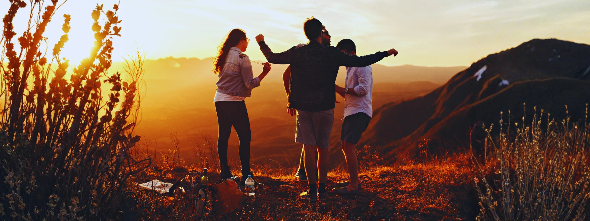 Friends at sunset on a mountain ridge celebrating recovery and support, symbolizing hope after quitting Xanax.