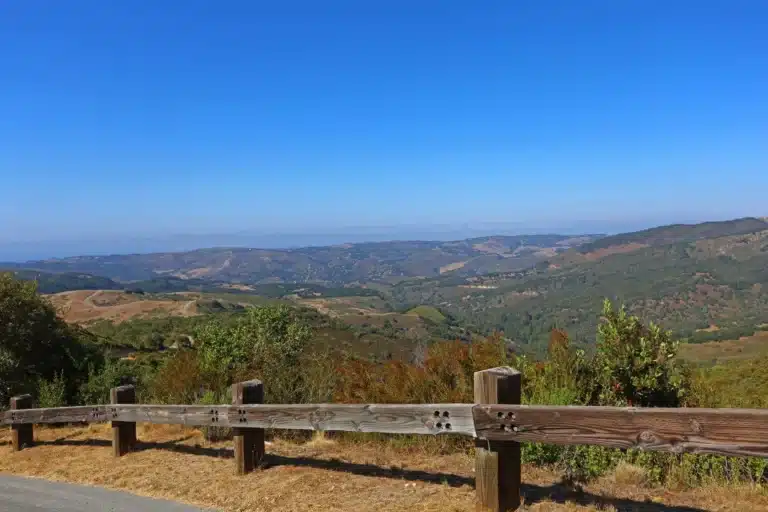 Scenic overlook of Carmel Valley hills with wide vineyard landscape under clear blue sky.