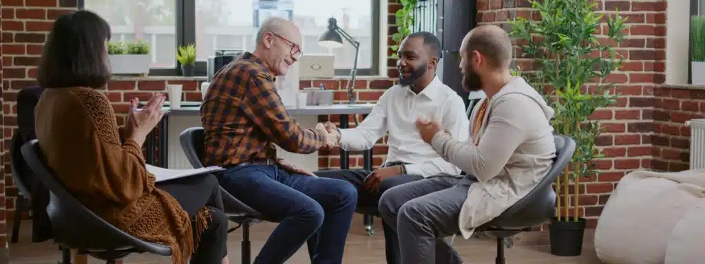 Elderly dementia patient receiving compassionate care in a residential treatment facility with family members present.