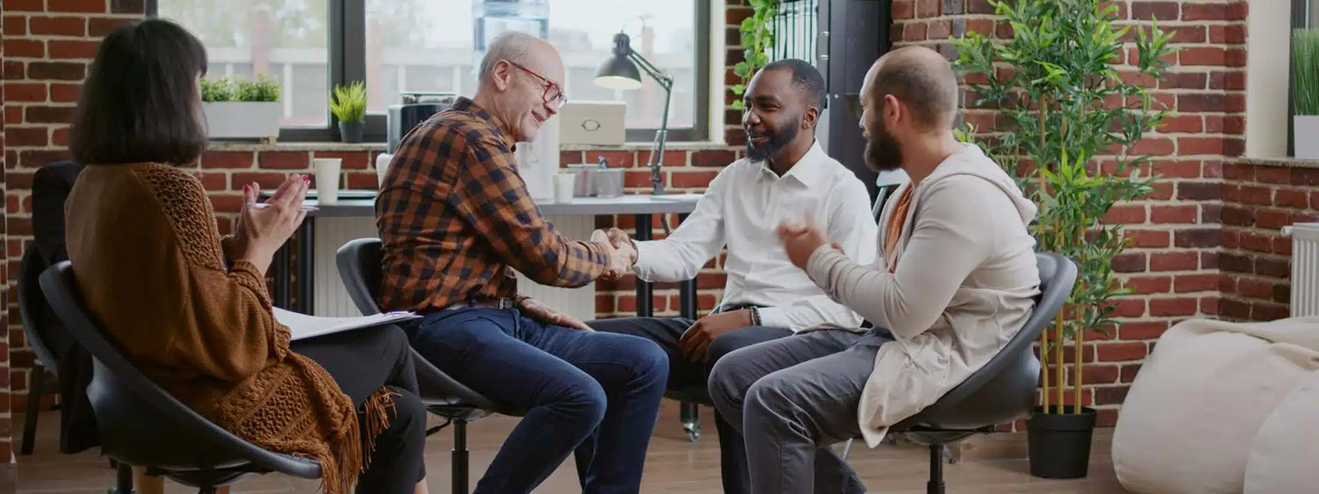 Elderly dementia patient receiving compassionate care in a residential treatment facility with family members present.