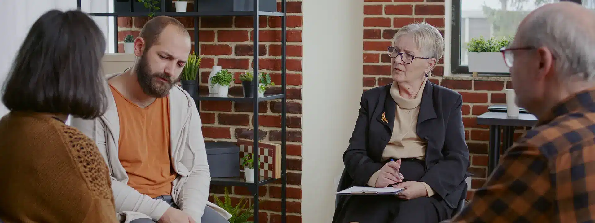 Person discussing emotional struggles with a therapist during a mental health treatment consultation