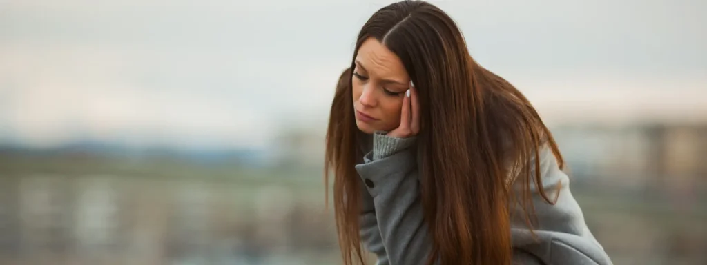 Person staring out window reflecting on internal emotional struggle despite functioning well