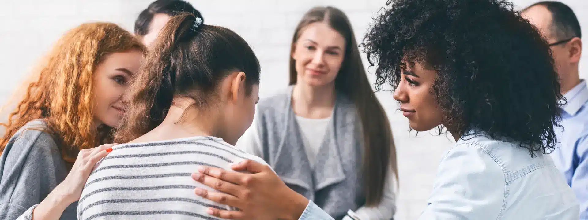 Individual seeking professional mental health support during a one-on-one therapy session in a warm, welcoming environment.