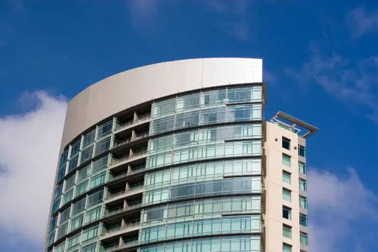 A tall building featuring a prominent clock on its facade, showcasing architectural design and timekeeping.