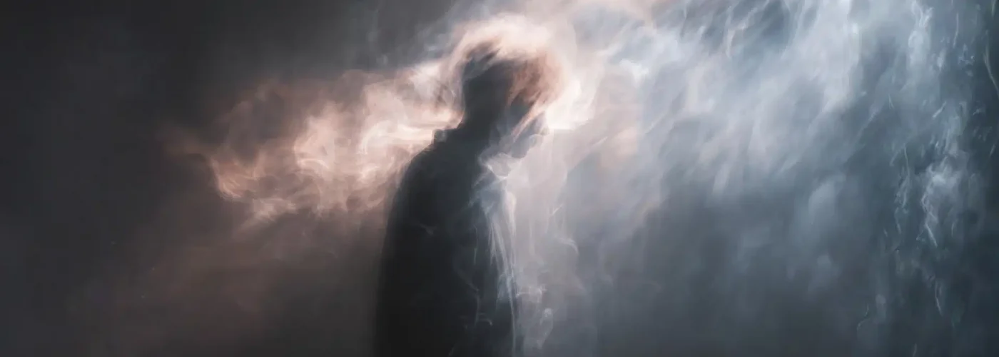 Silhouette surrounded by mist and light representing confusion and withdrawal symptoms after stopping alprazolam suddenly.