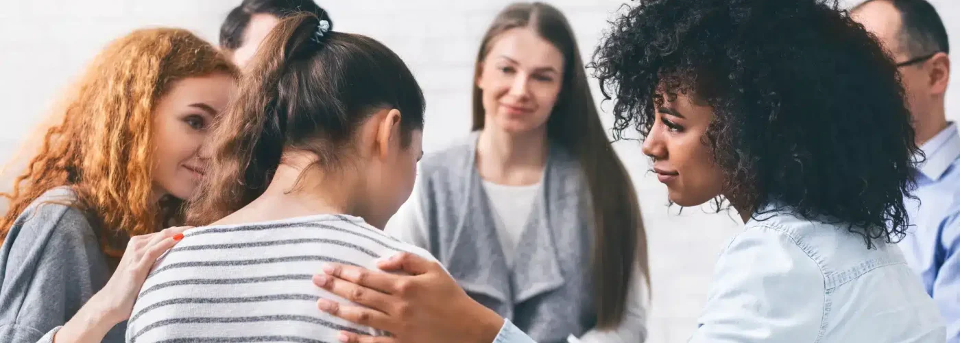 Individual seeking professional mental health support during a one-on-one therapy session in a warm, welcoming environment.