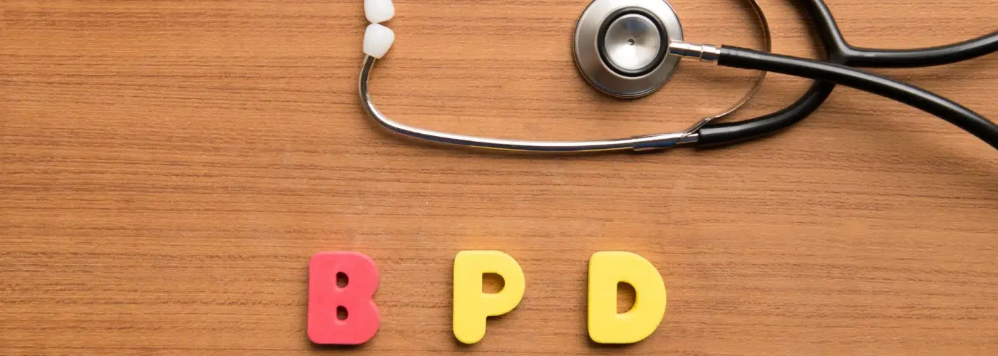 Colorful foam letters spelling “BPD” beside a stethoscope on a wood surface, symbolizing medical awareness and mental health treatment for borderline personality disorder.